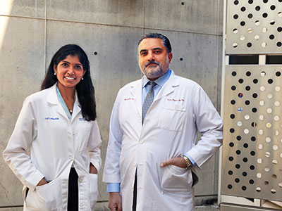 UCI Health surgical oncologist Dr. Maheswari Senthil, left, stands with fellow gastric cancer research Dr. Farshid Dayyani.