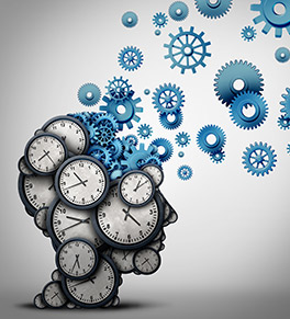 Image shows an illustration of human head covered in clock faces, each displaying a different time. A blue section at the top of the head shows gears flying from the prefrontal cortex, part of the brain affected by time blindness in people with ADHD and other cognitive disorders.