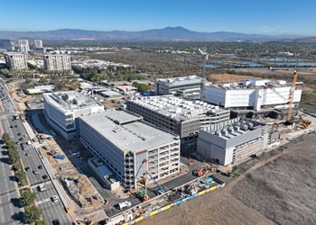 an aerial view taken by a drone of uci health irvine on a sunny day and its central utility plant, which is the first all electric plant to power a medical center