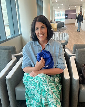 Wendy Garcia, one of the first patients treated on opening day at the new UCI Health cancer center in Irvine, holds a complimentary gift bag.