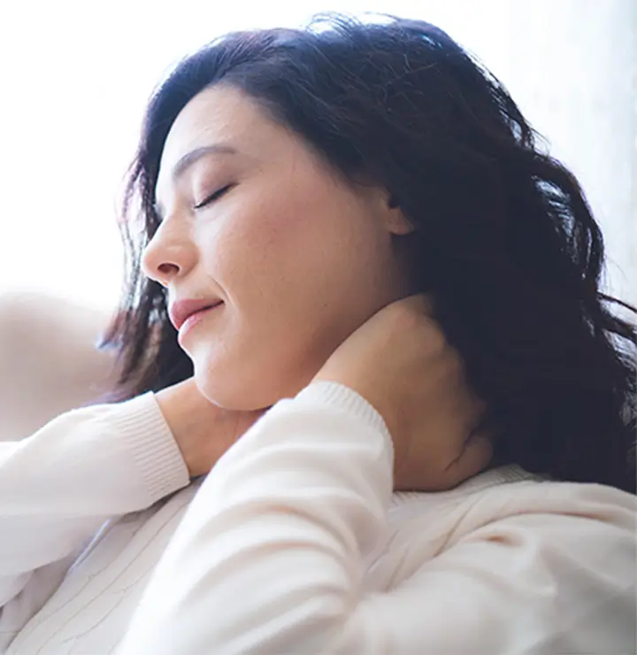 Women rubbing her neck to loosen tension.